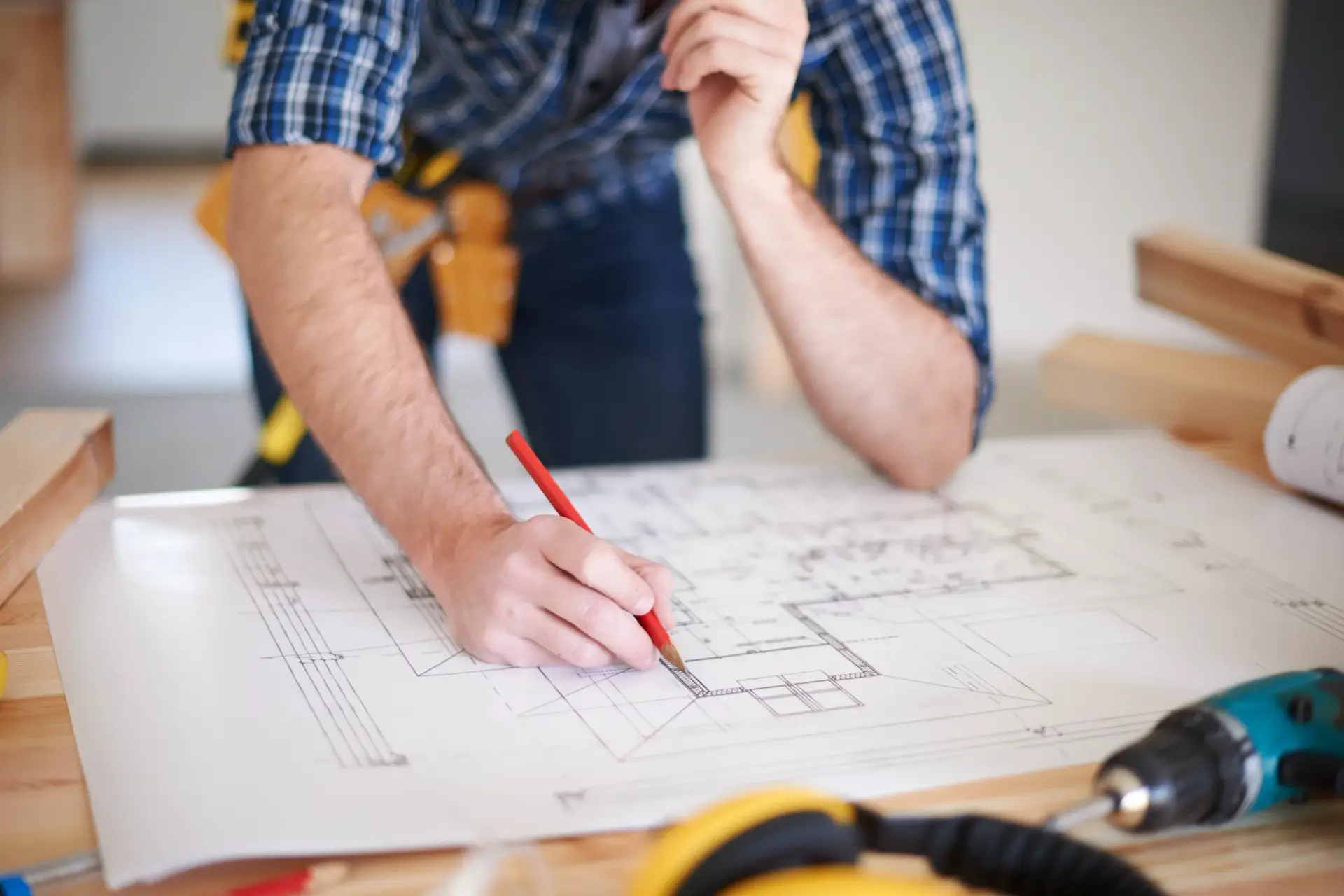 Close up of an architect drafting blueprints alongside professional Custom Home Builders in Lyman SC.