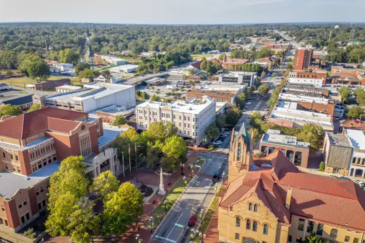 Aerial perspective of downtown Anderson, SC buildings with large brick structure in foreground, custom home builders in Anderson SC.
