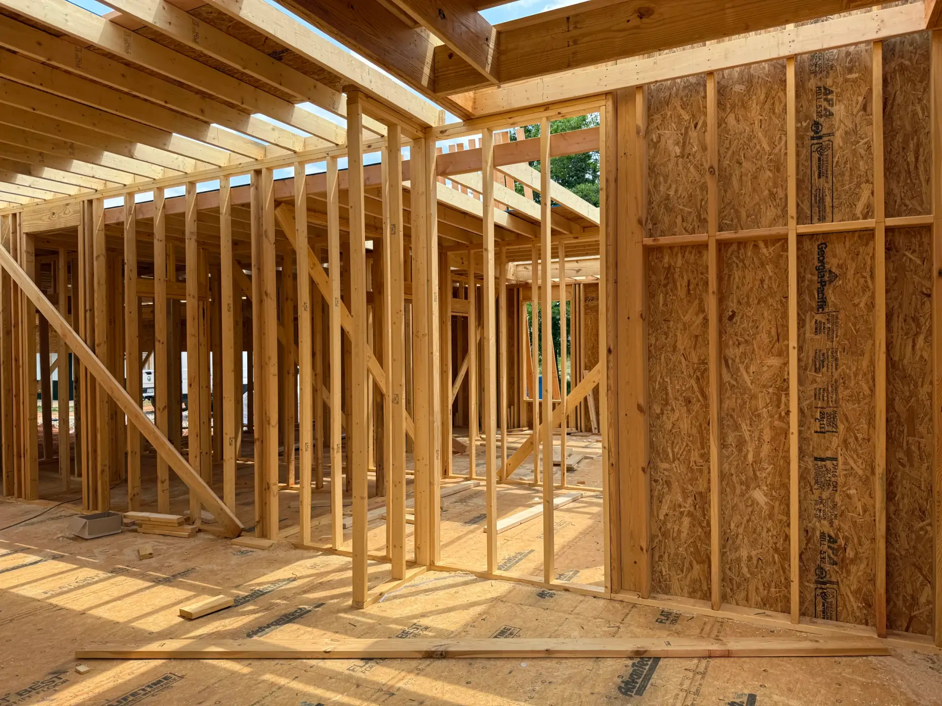 Interior wooden wall studs and ceiling joists during the framing of a Custom Luxury Farmhouse.